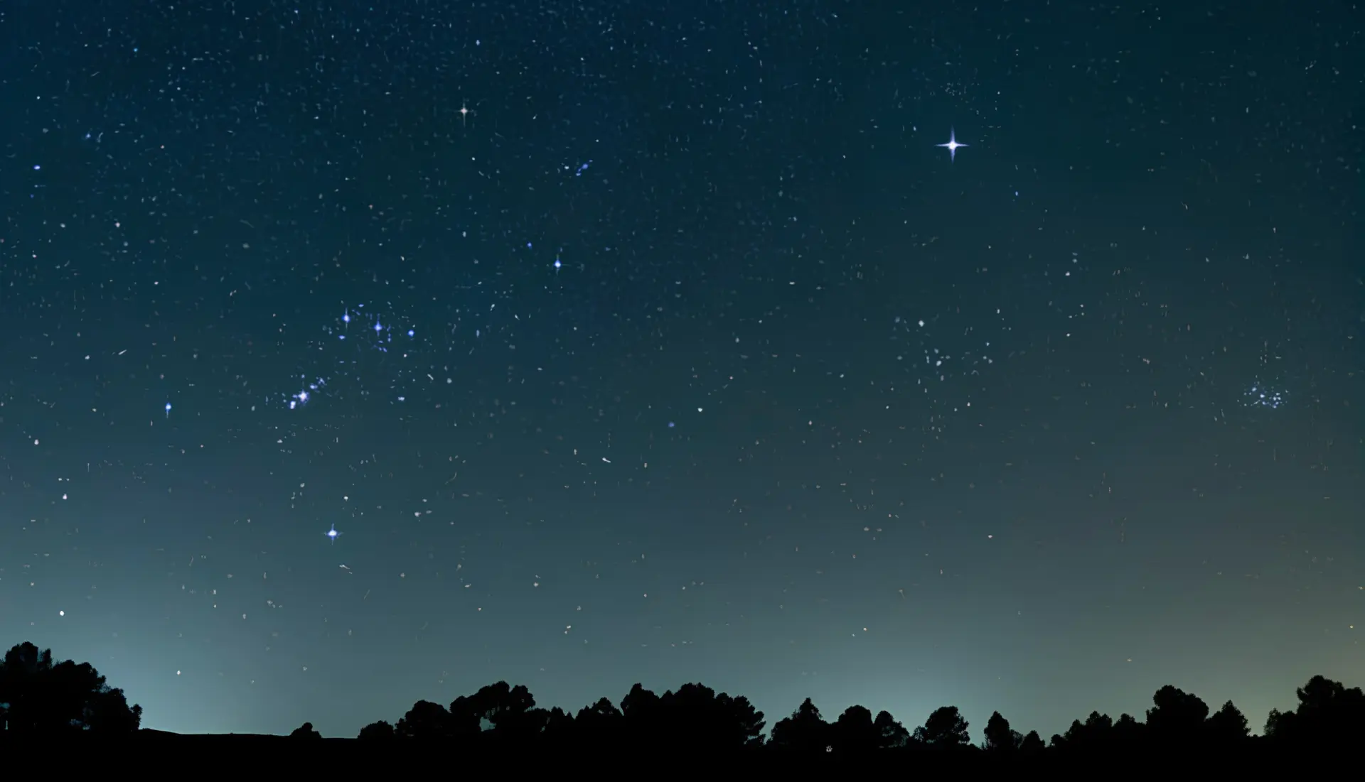 North Star above a starlit treeline at twilight